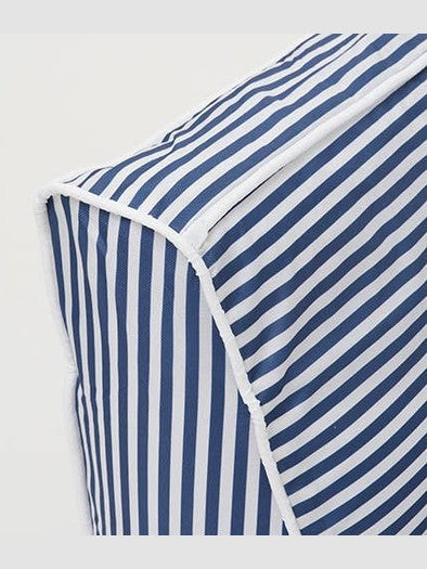 Close-up of white piping detail on navy striped pool float fabric