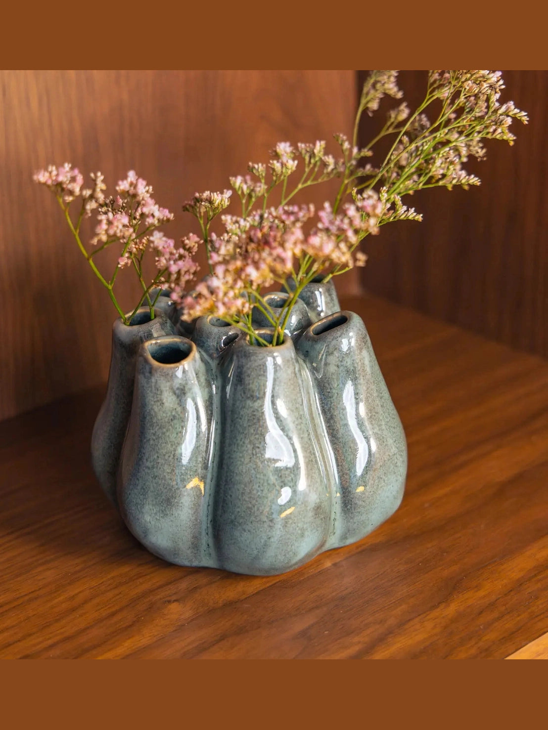 Speckled teal artichoke ceramic flower holder with dried pink statice bouquet
