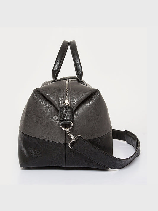 Grey and black pebbled leather duffel bag side view with vertical zipper detail