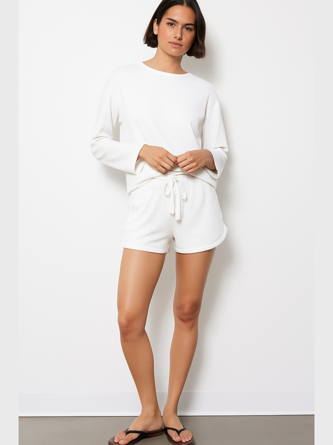 White roll cuff tie waist shorts with adjustable bow front and cuffed hems