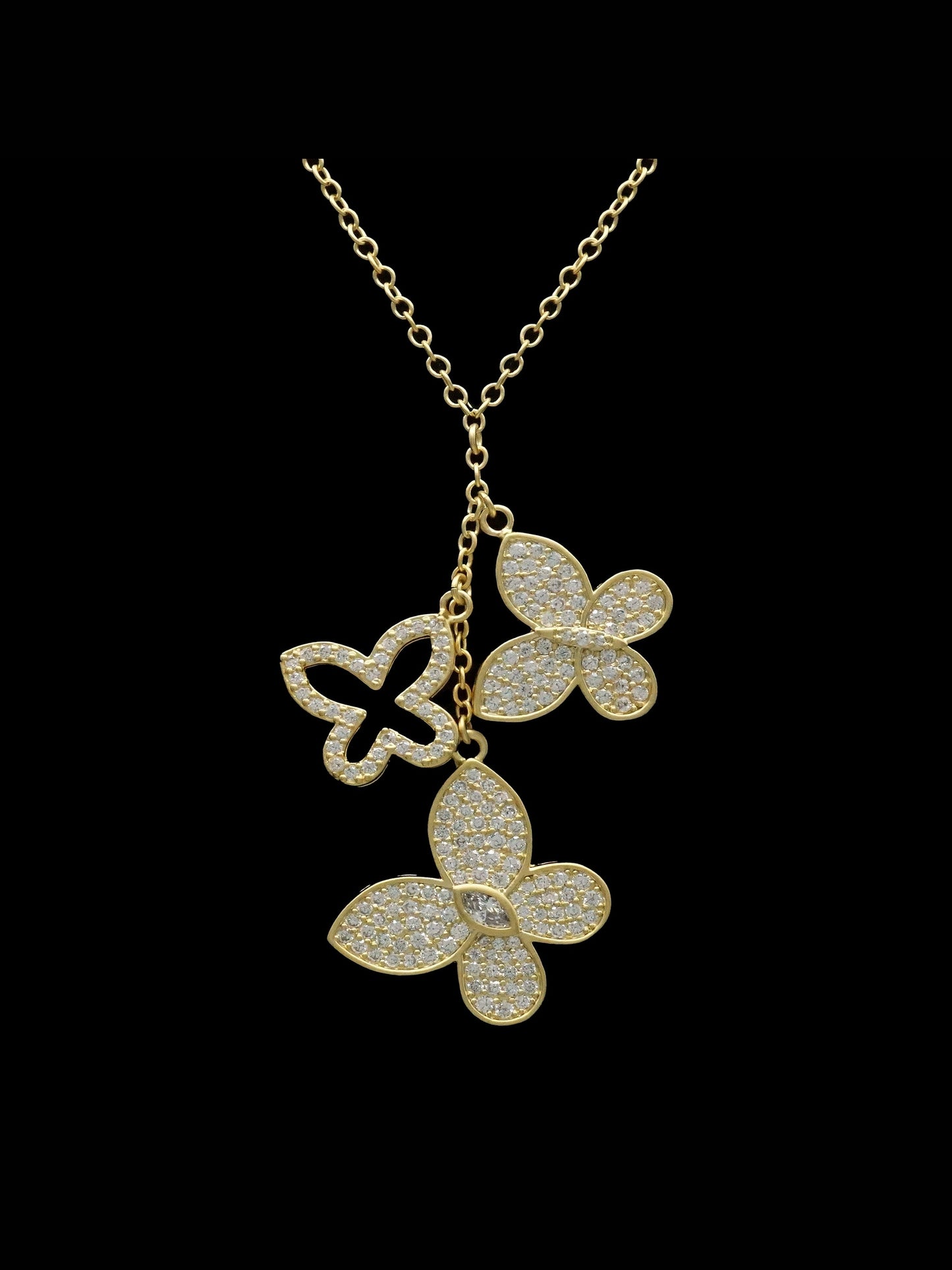 Gold-tone pave butterfly Y-necklace with three crystal pendants on black background