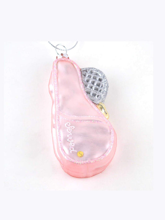 Close-up of pink tennis bag ornament with glitter trim and racket detail