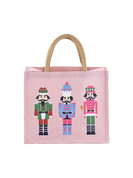 Pink woven jute holiday tote with nutcracker soldier illustrations and rope handles